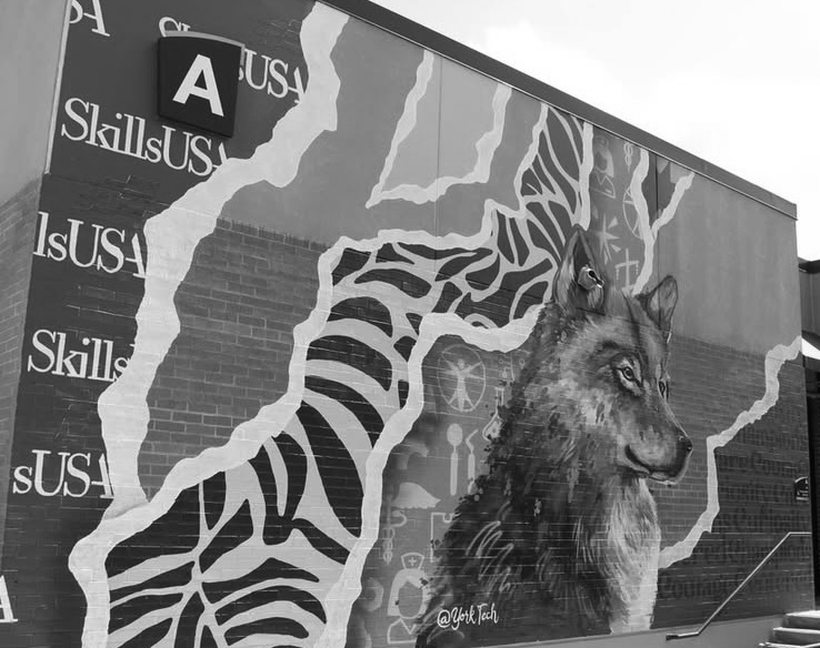 Mural of a wolf and zebra on a building wall with 'SkillsUSA' branding.